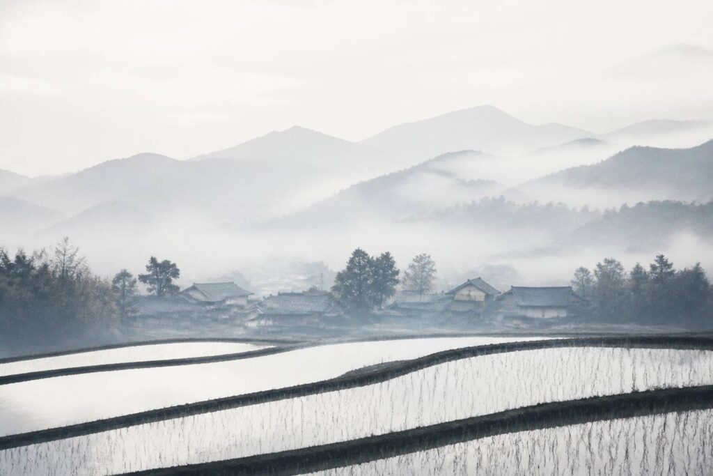 Village rural japonais entre rizières et montagnes brumeuses